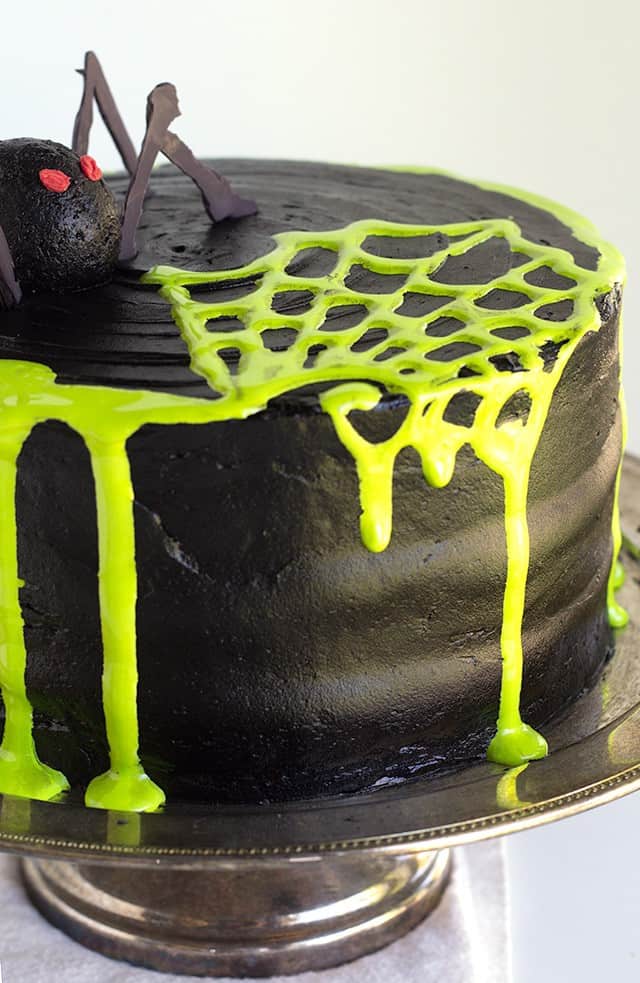 Spooky Spiderweb Cake - the perfect chocolate Halloween cake with black chocolate frosting and toxic green fluff sludge. It should be at all the parties!