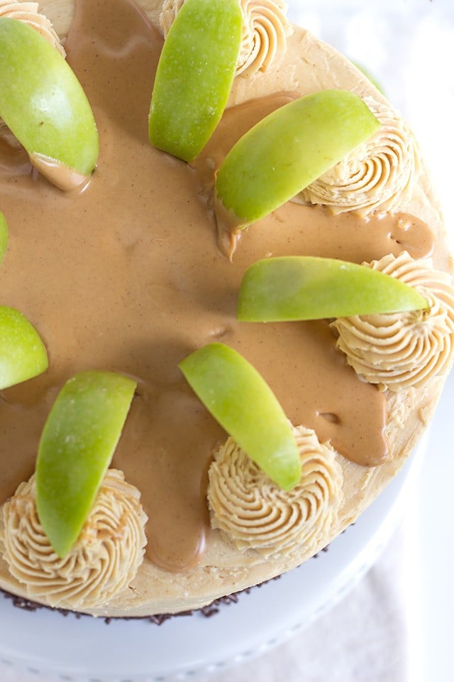 Top view, looking down on an Apple Cake with Peanut Butter Frosting garnished with green apple slices