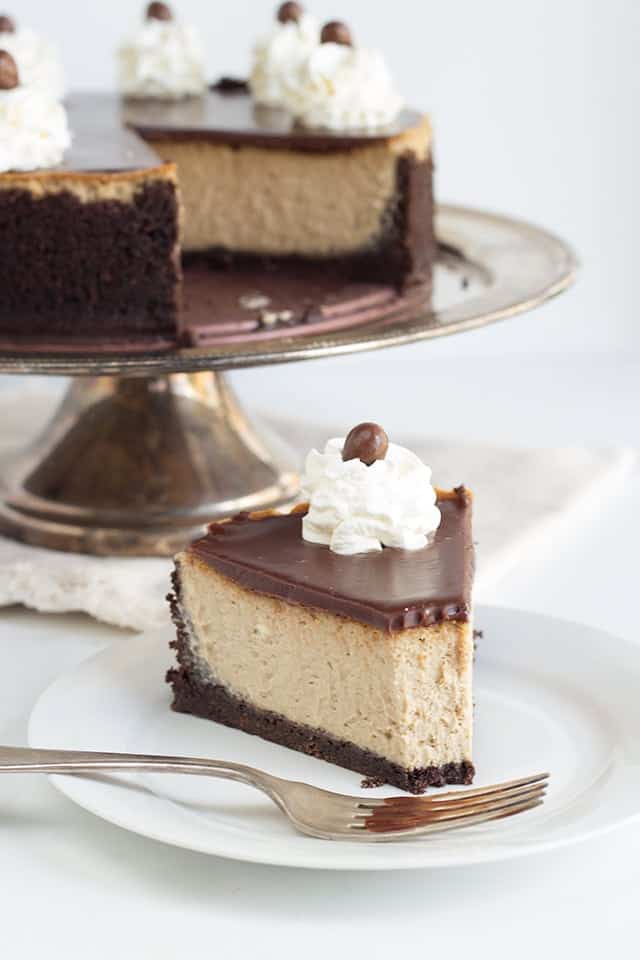 slice of mocha cheesecake on a white plate with a fork