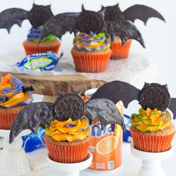 Oreo crusted orange fanta cupcakes with bats on top.