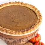 A tantalizing Pumpkin Gingersnap Pie presentation on a wooden board.