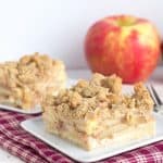 Two slices of apple crumble cake on a plate.