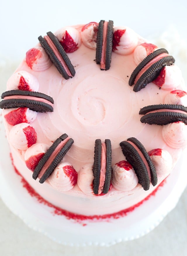 Peppermint Oreo Crunch Cake - vanilla cake with a peppermint oreo crunch stuffed inside and frosting with a baby pink peppermint frosting. 