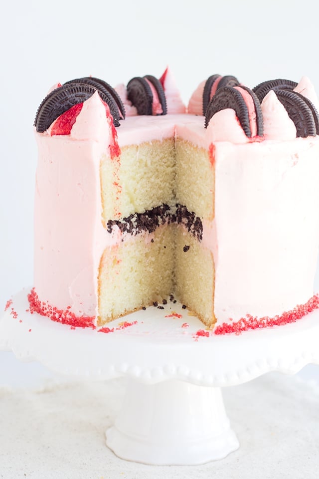 Peppermint Oreo Crunch Cake - vanilla cake with a peppermint oreo crunch stuffed inside and frosting with a baby pink peppermint frosting. 