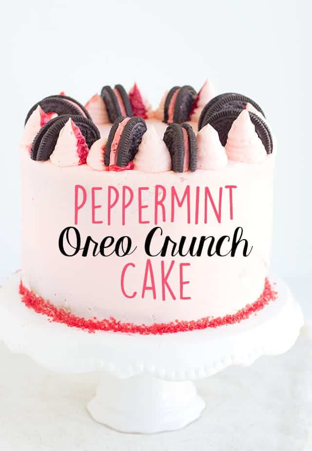 Showing whole peppermint oreo crunch cake on white cake plate with text on photo