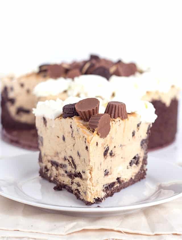 slice of chocolate peanut butter cheesecake with Oreo cookies and Reese's peanut butter cups