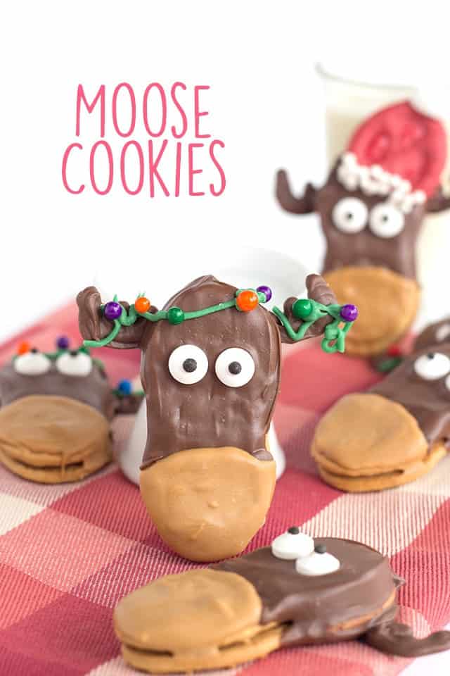 Moose cookies sit next to a glass of milk on the table.