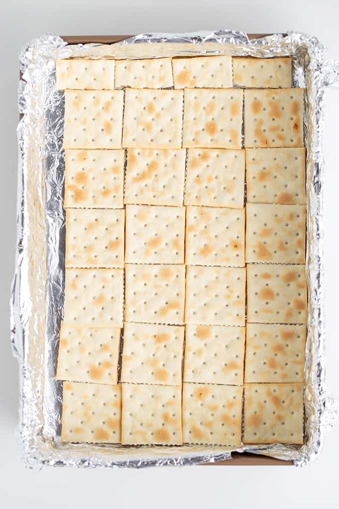 overhead image of the saltine crackers in a foil lined pan