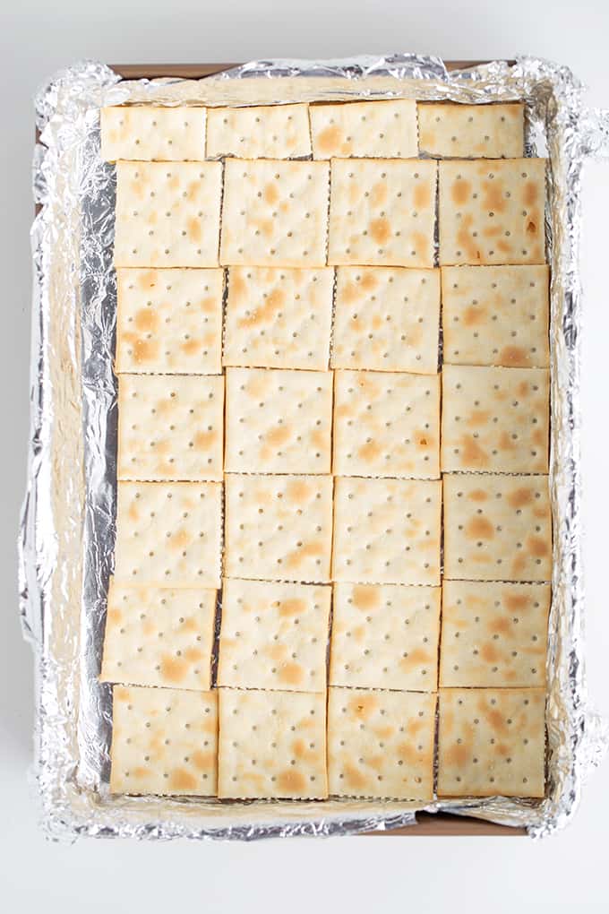 overhead image of the saltine crackers in a foil lined pan