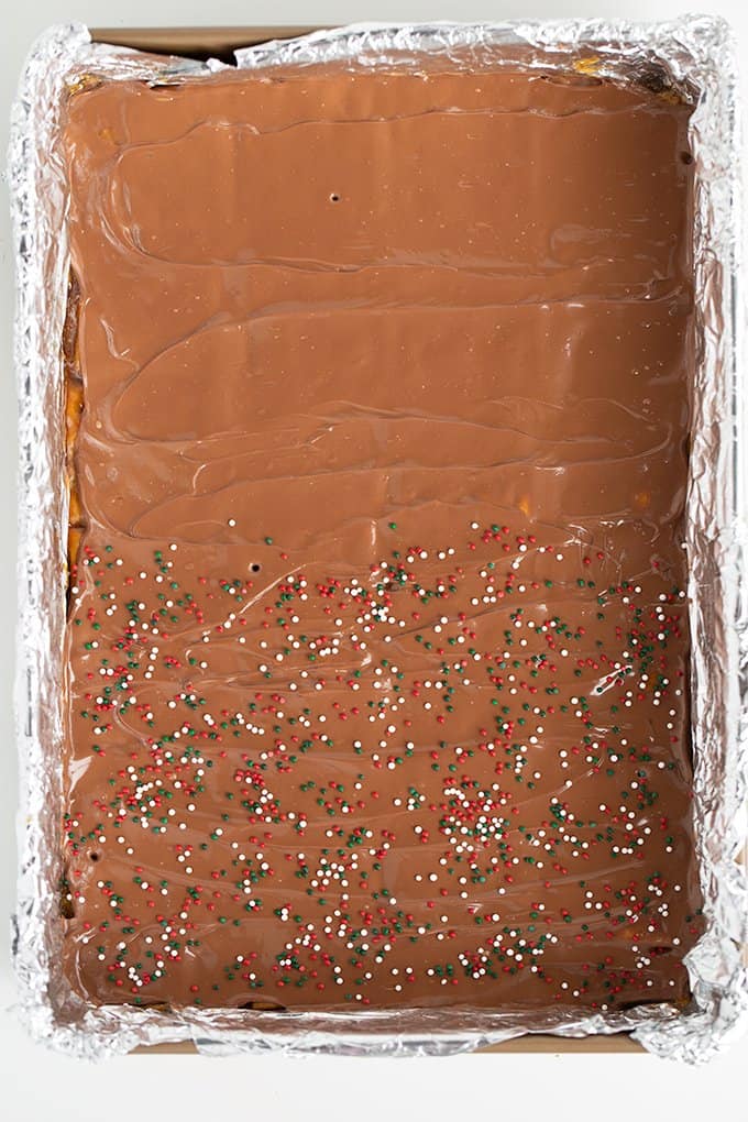 overhead image of the saltine cracker candy with sprinkles on half and plain chocolate on the other half