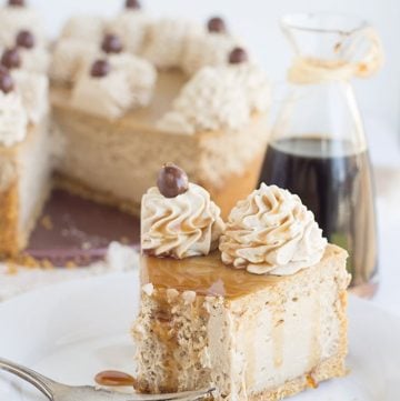 A slice of caramel cheesecake on a plate with a fork, perfect for pairing with a cup of coffee.