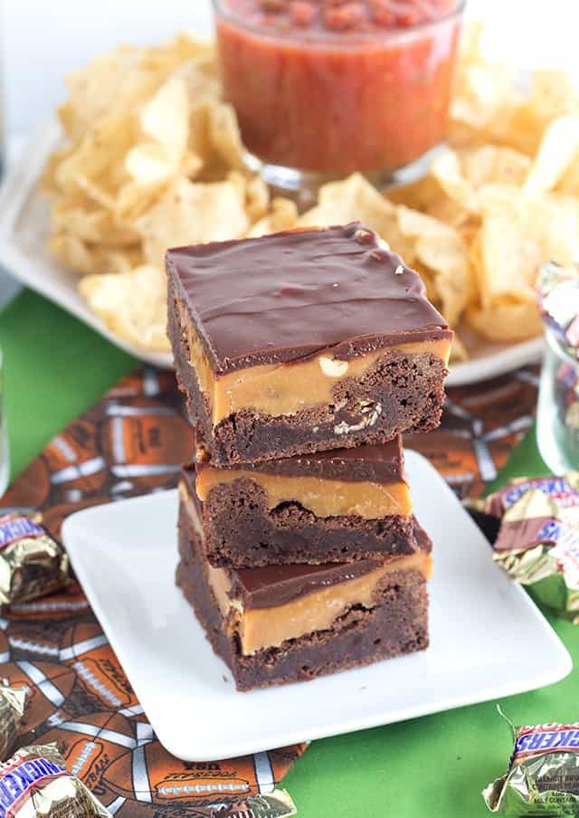 SNICKERS® Brownies stacked on a dessert plate