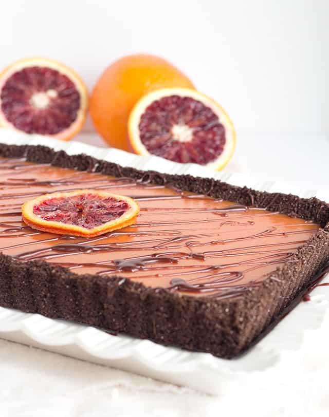 Chocolate Blood Orange Tart - chocolate graham cracker crust with a blood orange curd and a milk chocolate ganache drizzle.