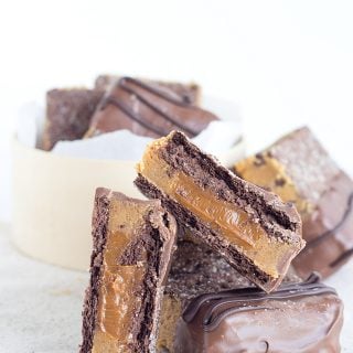 A stack of Dulce De Leche and Grahamwiches chocolate peanut butter bars in a box.
