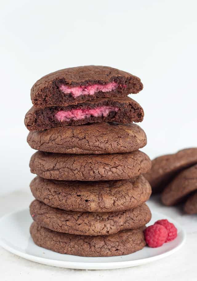 A stack of raspberry-filled fudge cookies on a plate.