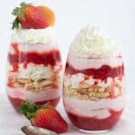 Two Strawberries and Cream Trifles with whipped cream and strawberries.