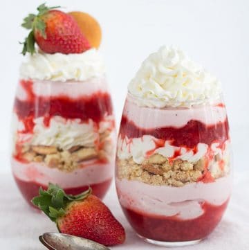 Two Strawberries and Cream Trifles with whipped cream and strawberries.