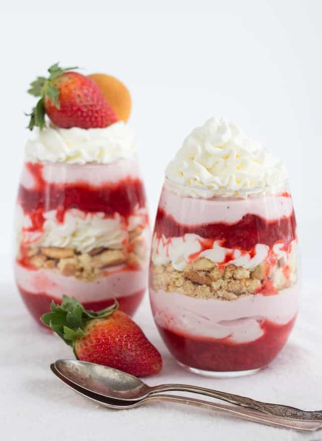 Strawberries and Cream Trifles - layers of strawberries with syrup, strawberry mousse, vanilla cookies and whipped cream. This is not only beautiful, but tastes amazing!