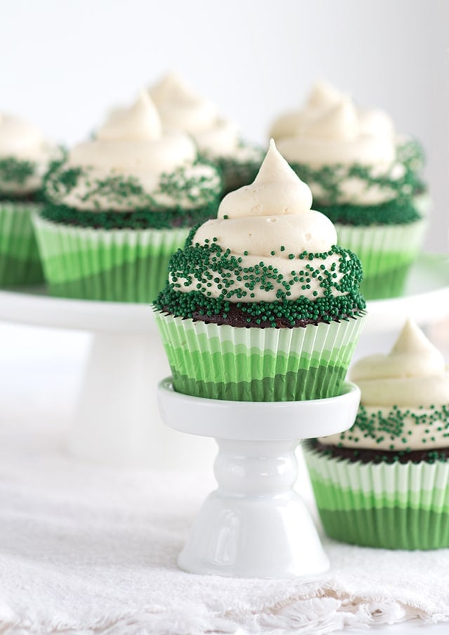 dessert plate with Chocolate Guinness Cupcakes with Baileys Cream Cheese Frosting topped with green sprinkles