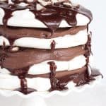 A stack of Chocolate Malted Milk Pavlova on a cake stand.