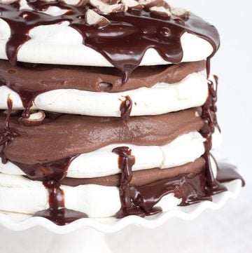 A stack of Chocolate Malted Milk Pavlova on a cake stand.