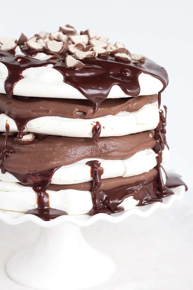 A stack of Chocolate Malted Milk Pavlova on a cake stand.