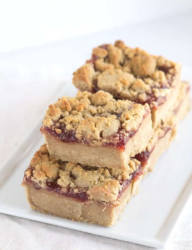 Peanut Butter Jam Bars - These bars have a peanut butter cookie base, a thick layer of strawberry jam, and a peanut butter crumble on top.