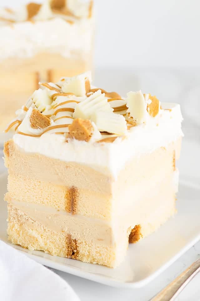 No Bake White Chocolate Peanut Butter Dessert - layers of buttery pound cake, peanut butter mousse, white chocolate ganache and topped with white chocolate peanut butter cups! This is the perfect summer treat!