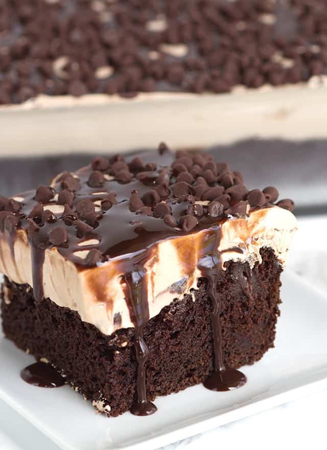 Chocolate Poke Cake drizzled with chocolate syrup