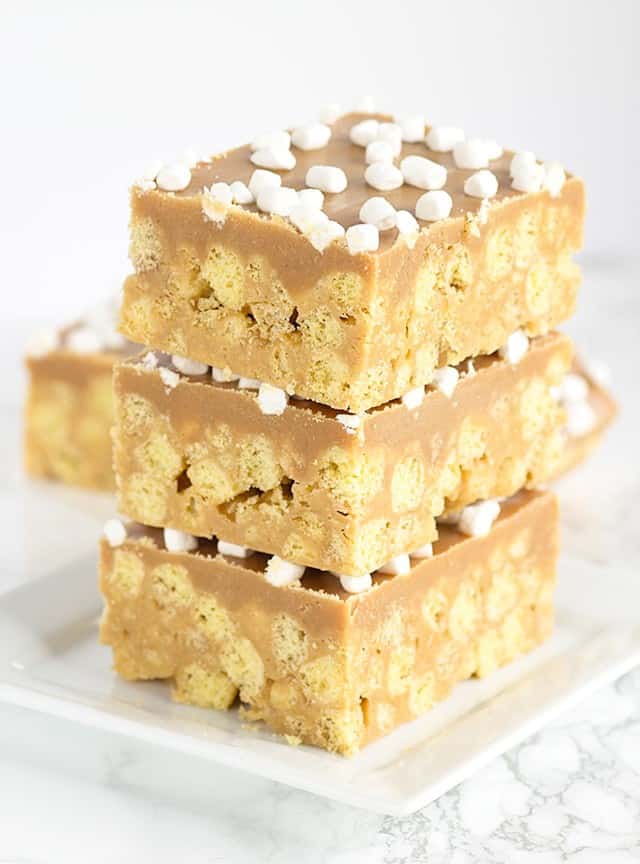 No Bake Peanut Butter Cereal Bars stacked on a plate.