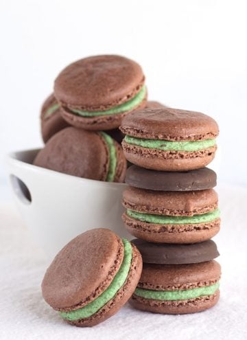 Thin Mint Chocolate Macarons - chocolate french macarons stuffed with a gorgeous green frosting is minty and packed full of crushed thin mint cookies.