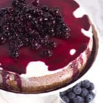 A blueberry cheesecake topped with fresh blueberries.