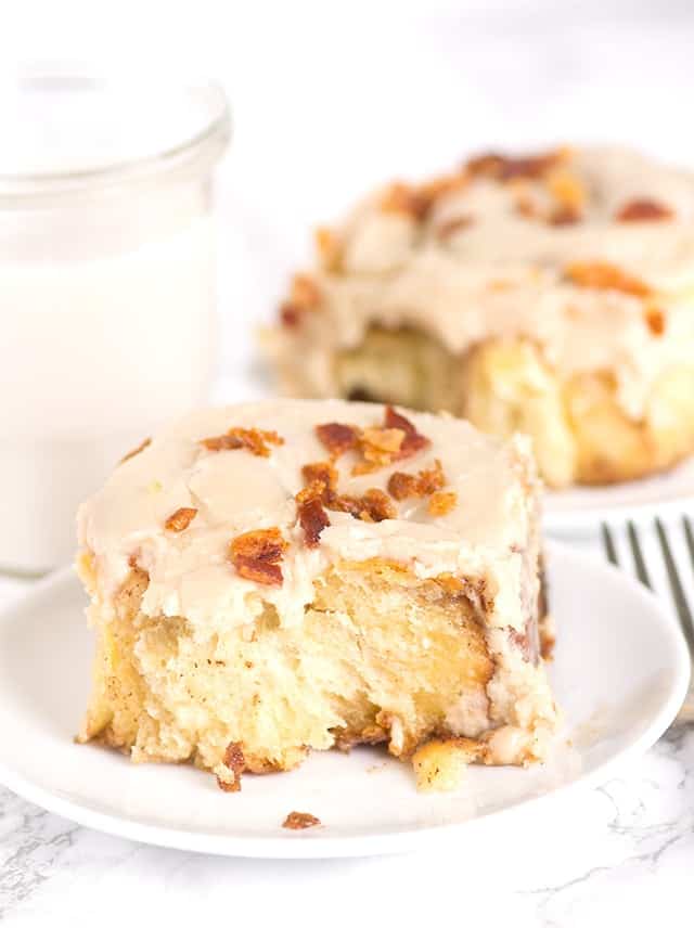 A slice of cinnamon roll on a plate.