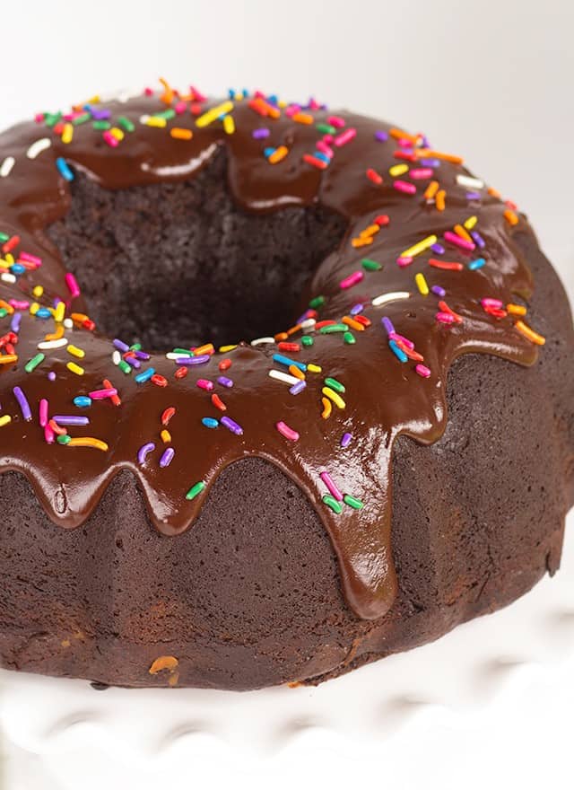 A chocolate bundt cake with chocolate icing and sprinkles, ideal for fans of chocolate and indulgence.