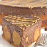 A decadent slice of Chocolate Peanut Butter Cheesecake on a plate.