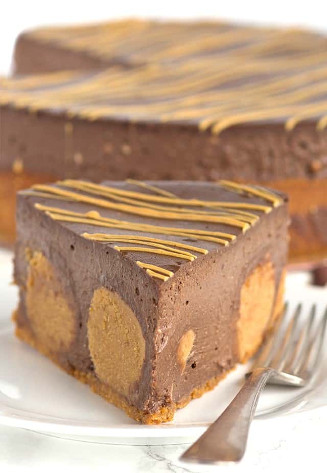 A decadent slice of Chocolate Peanut Butter Cheesecake on a plate.