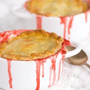 Two strawberry pot pies in two white bowls.