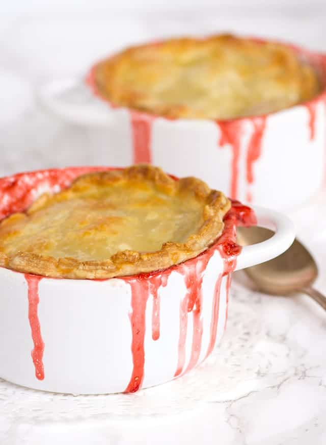 Two strawberry pot pies in two white bowls.