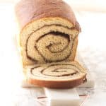 A scrumptious cinnamon swirl bread on a cutting board.