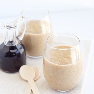 Two glasses of Maple Peanut Butter pudding with spoons on a table.