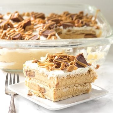 Peanut Butter Ice Box Cake - layers of graham crackers, peanut butter cream cheese stuffed with peanut butter cups, and whipped cream