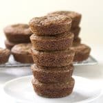 A stack of Double Ginger Molasses Cookies on a white plate.