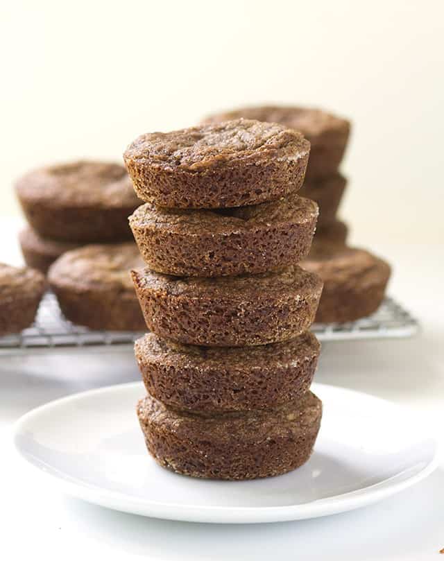 A stack of Double Ginger Molasses Cookies on a white plate.