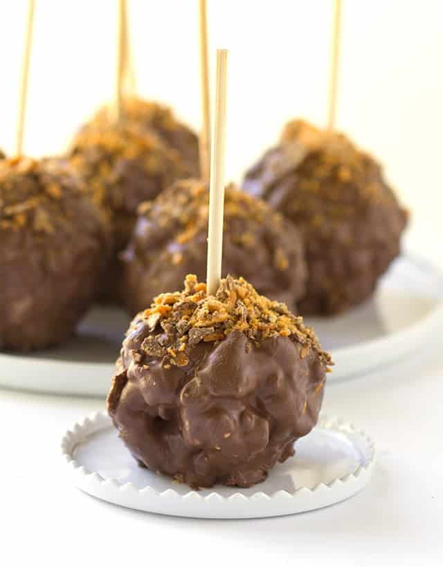 Chocolate Covered Peanut Butter Popcorn Balls - gooey peanut butter marshmallow popcorn balls coated with chocolate and sprinkled with butterfinger bits!