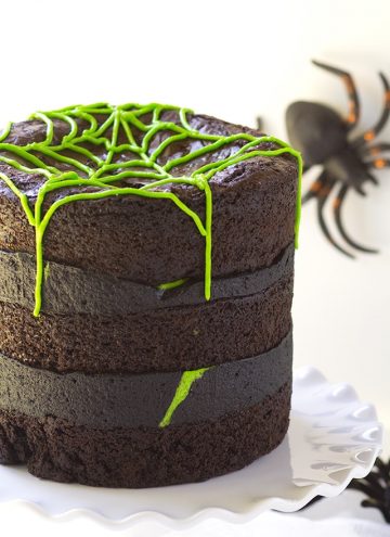 Spider Egg Brownie Cake - three layers of brownie stuffed with cadbury screme eggs (spider eggs). It's then filled with a mixture of chocolate and vanilla frosting!