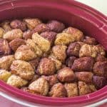 A crock pot filled with cinnamon rolls, also known as monkey bread.
