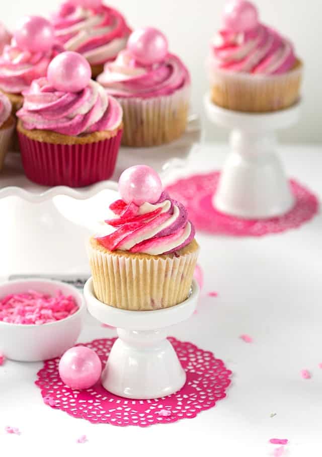 Strawberry Cupcakes - Vanilla cupcakes with finely diced strawberries mixed into the batter. The cupcakes are topped with pinks in honor of breast cancer awareness!