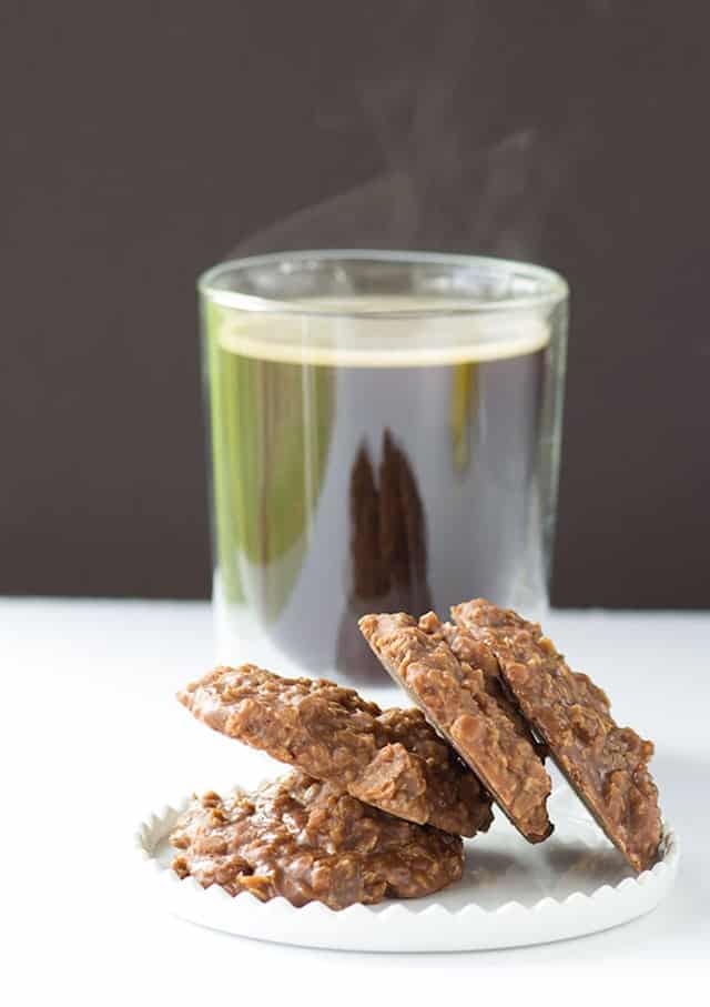 A plate of No Bake Cookies next to a cup of coffee.