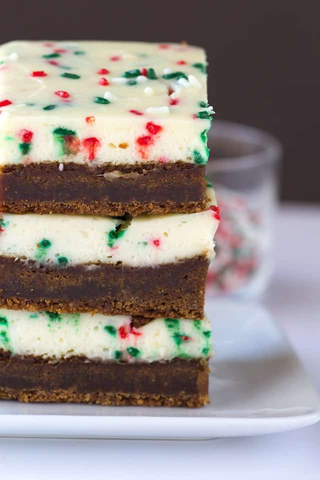 Molasses Cheesecake Bars - a dense and soft molasses cookie layer with a festive sprinkle packed cheesecake top.