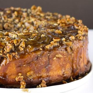 A cake with pecans on top.